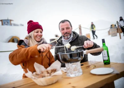Couple enjoying fondue in winter