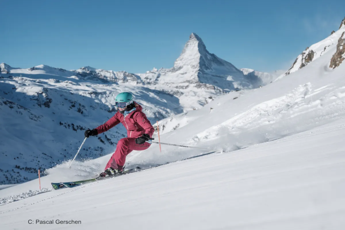 Skier descending on sunny day with Matterhorn in background