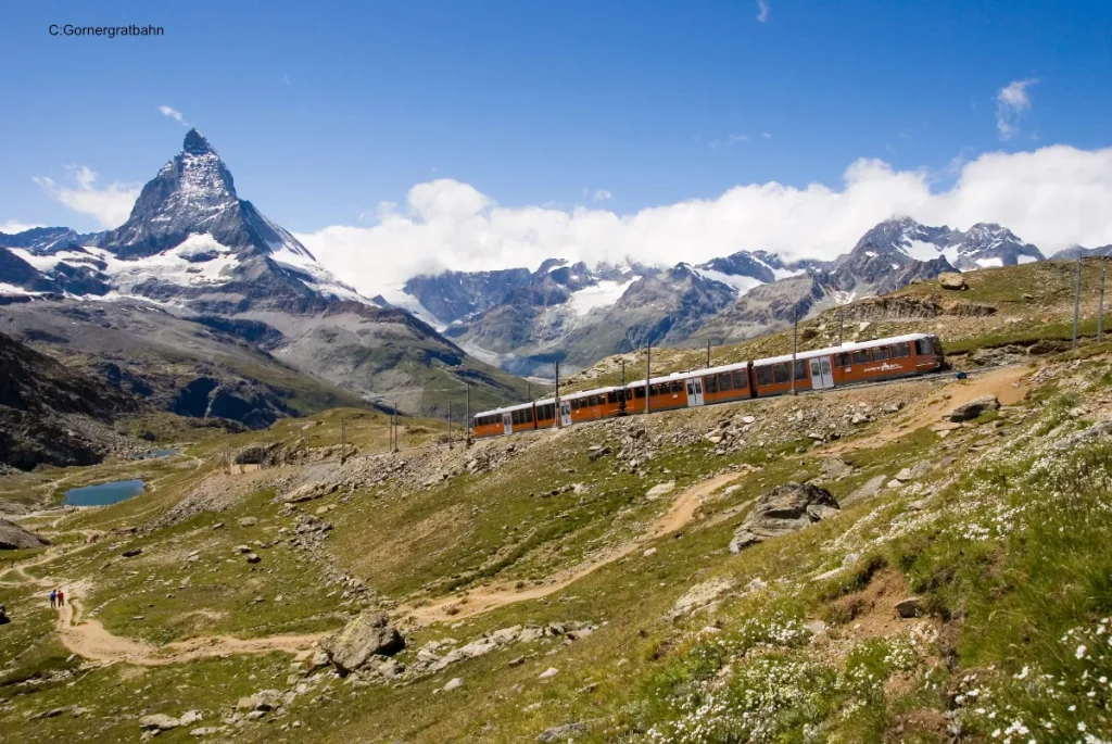 Train climbing in Alps with Matterhorn in background