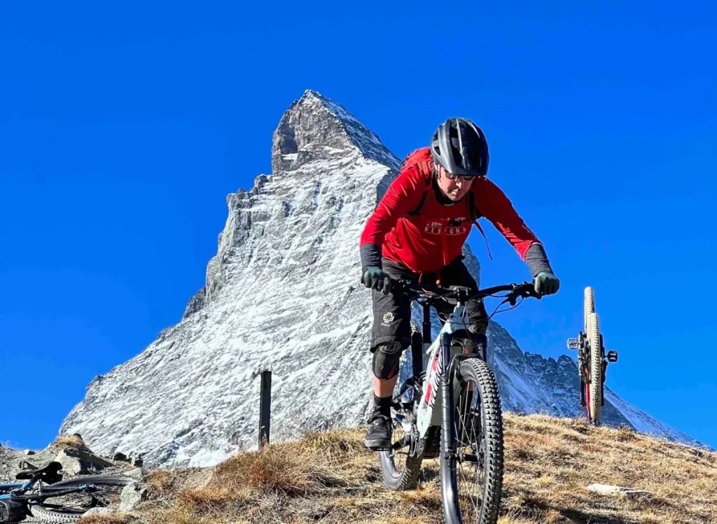 Everything Zermatt owner Nigel riding an e-bike near the Matterhorn